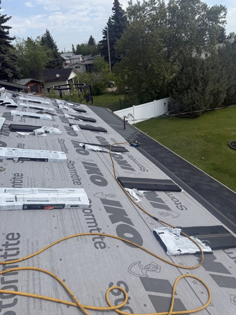 Active Crew Installing Shingles on Alberta Roof